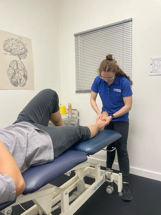 Physiotherapist assisting a client with a shoulder stretch at EPSA Health
