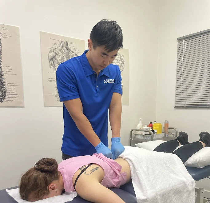 Physiotherapist assisting a client with a shoulder stretch at EPSA Health